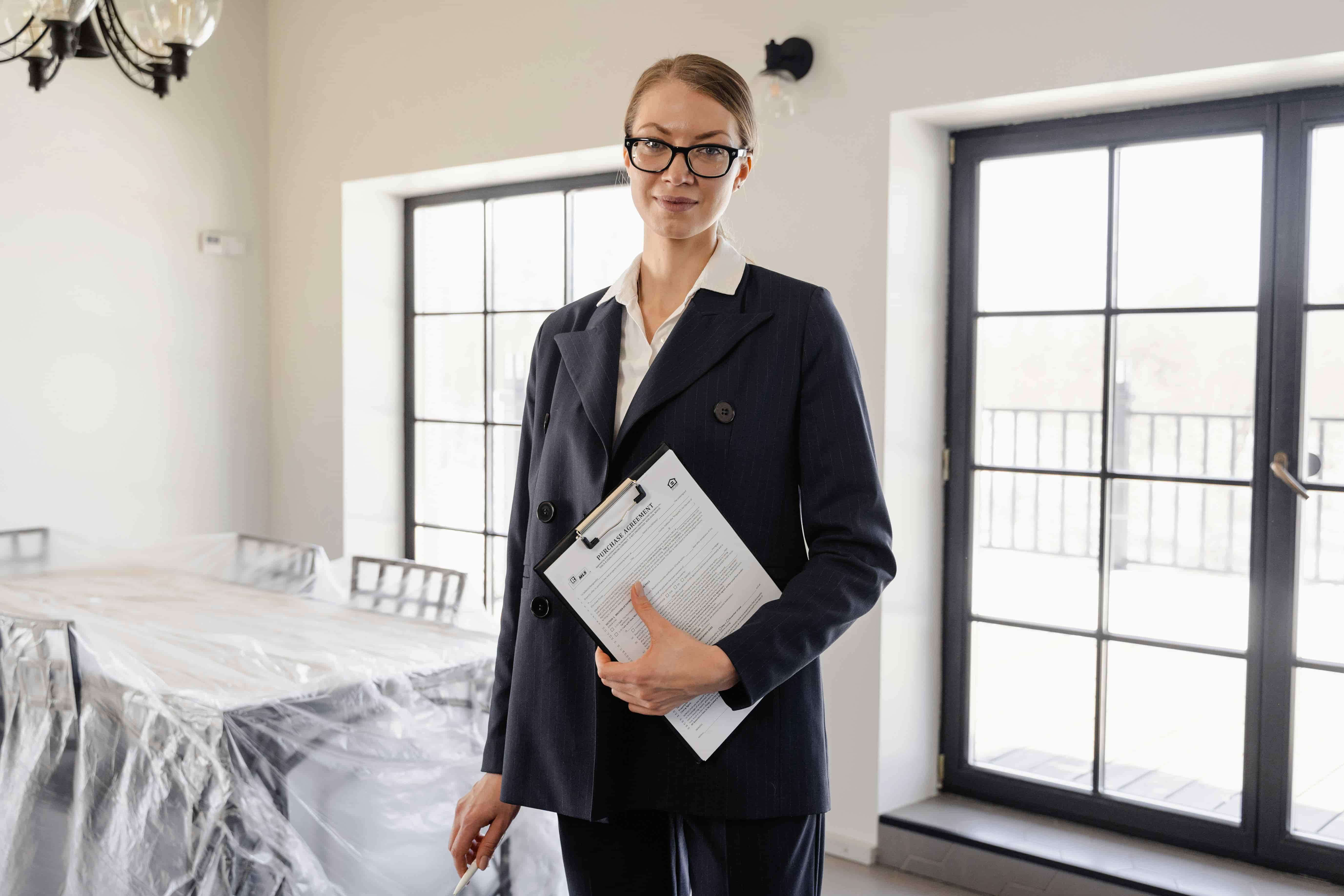 Professional woman preparing a property for inspection while starting her career in an entry level real estate job in Australia.