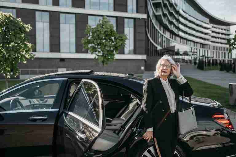 High-performing real estate agent with a luxury vehicle, illustrating the highest paying jobs in real estate in Australia.