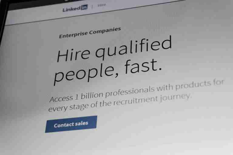 Executive recruiter in real estate reviewing LinkedIn profiles to identify senior property professionals